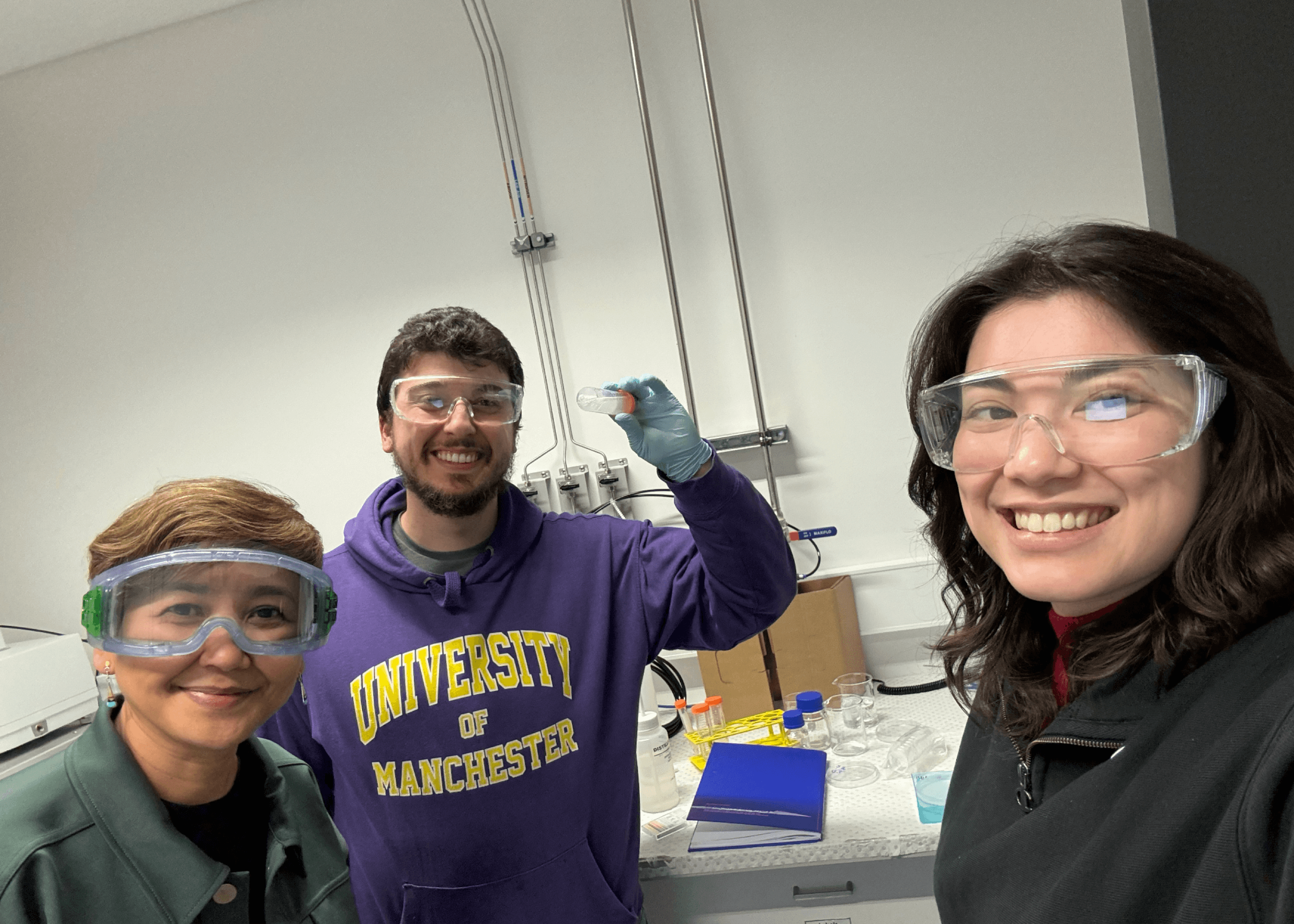 Alinta Furnell and her teammates wearing protective glasses in a lab.