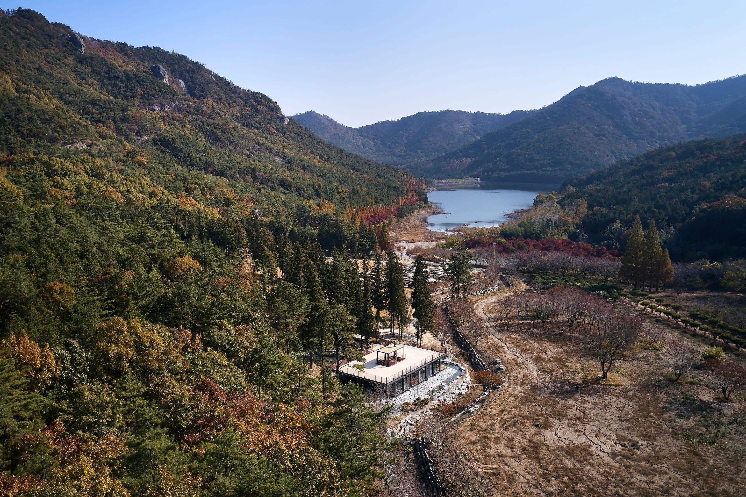 Choru Visitor Center, a square building nestled in a valley.