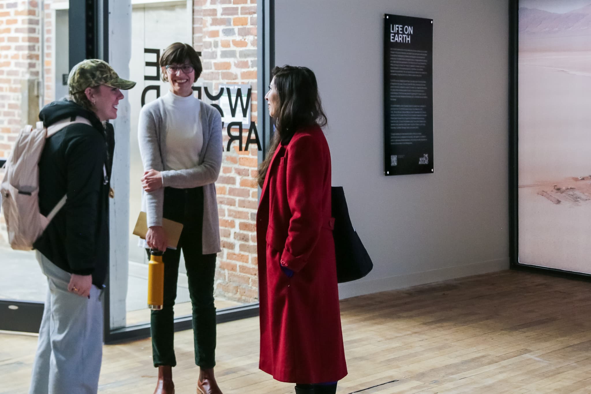 Teachers and students in conversation at the opening of Life On Earth at the University of Kentucky, College of Design.