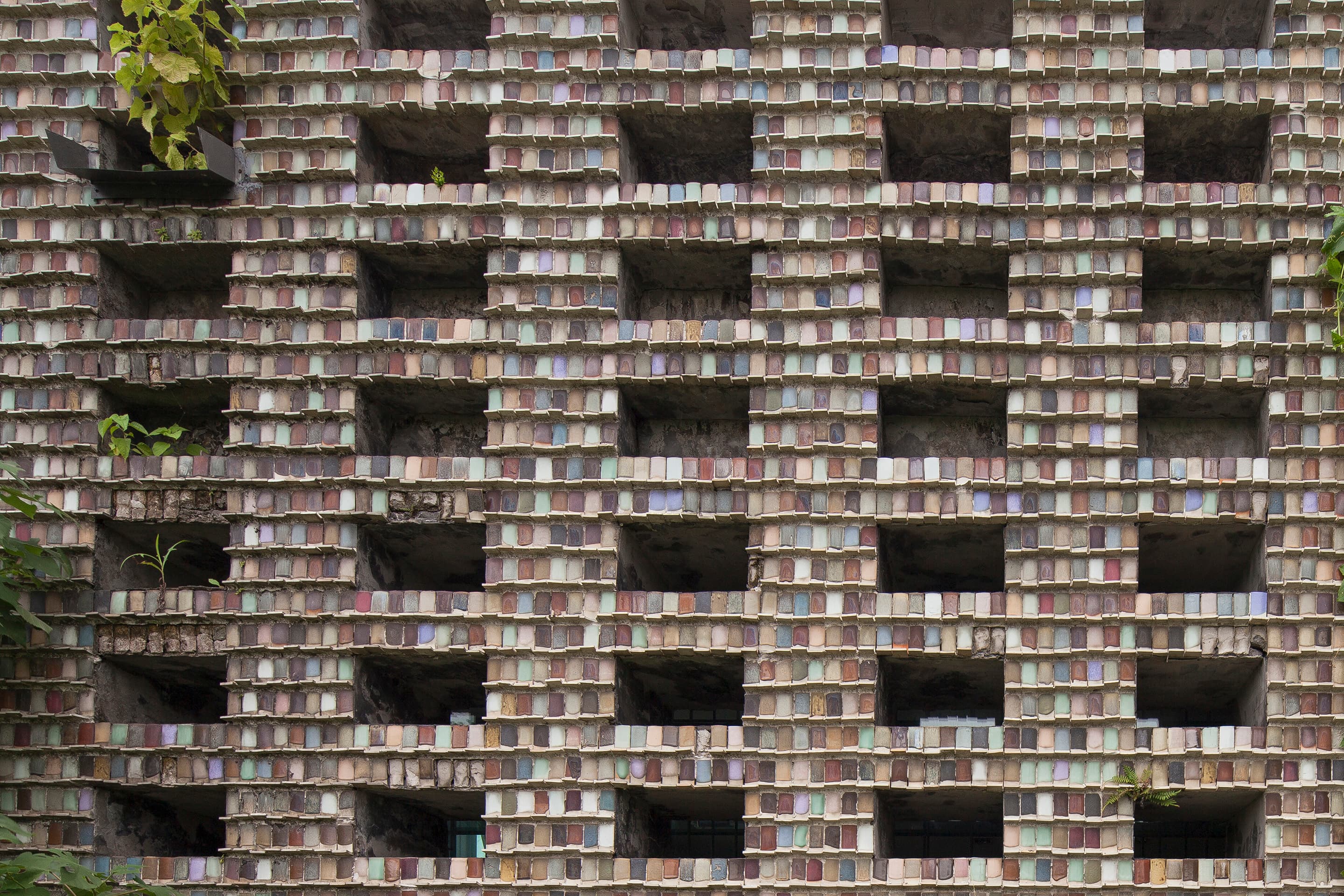 The rhythmic gridded facade of Ceramic House by Amateur Architecture Studio.