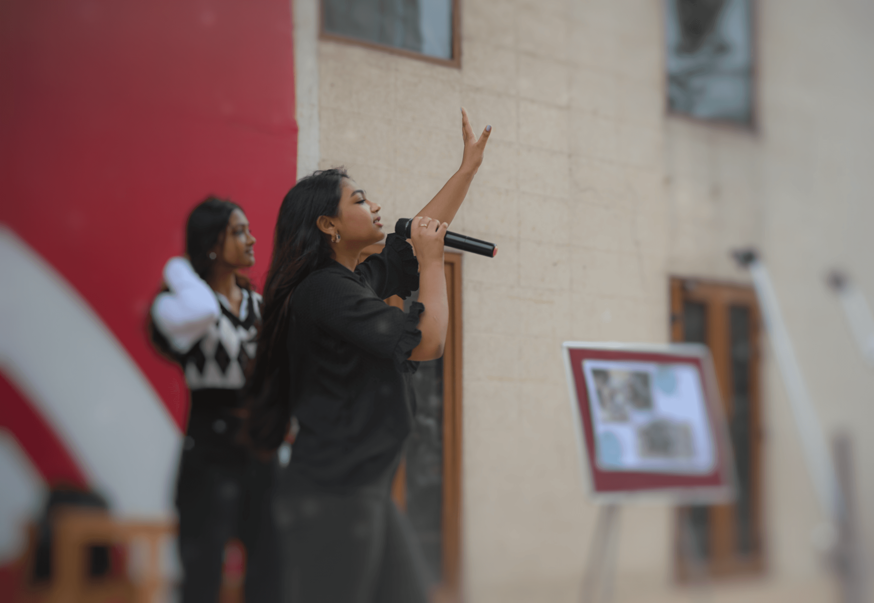 Sahithi Radha raises her hand while addressing the room at an e-waste awareness session.
