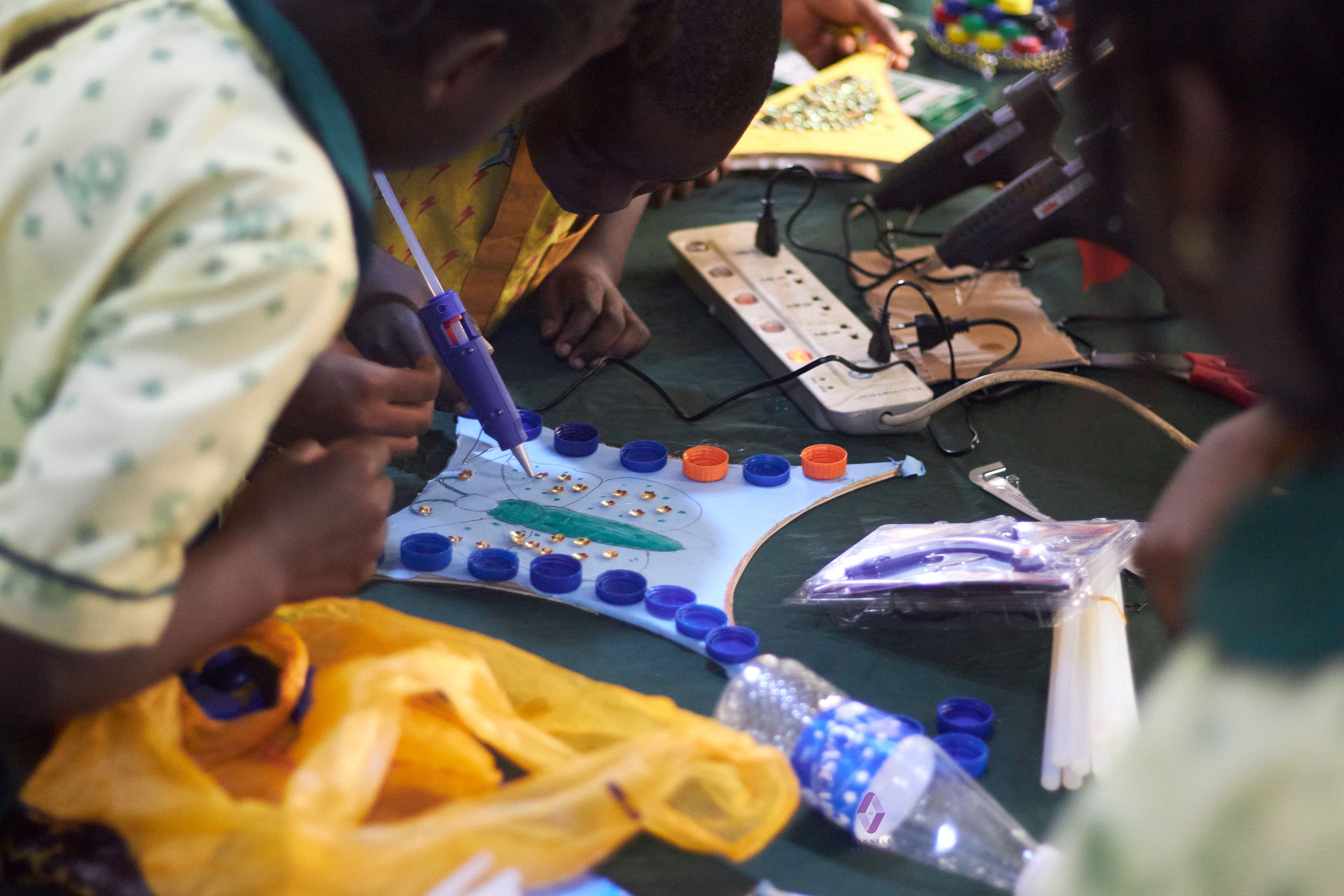Children doing arts and crafts at a community climate education session hosted by GreenQuest.