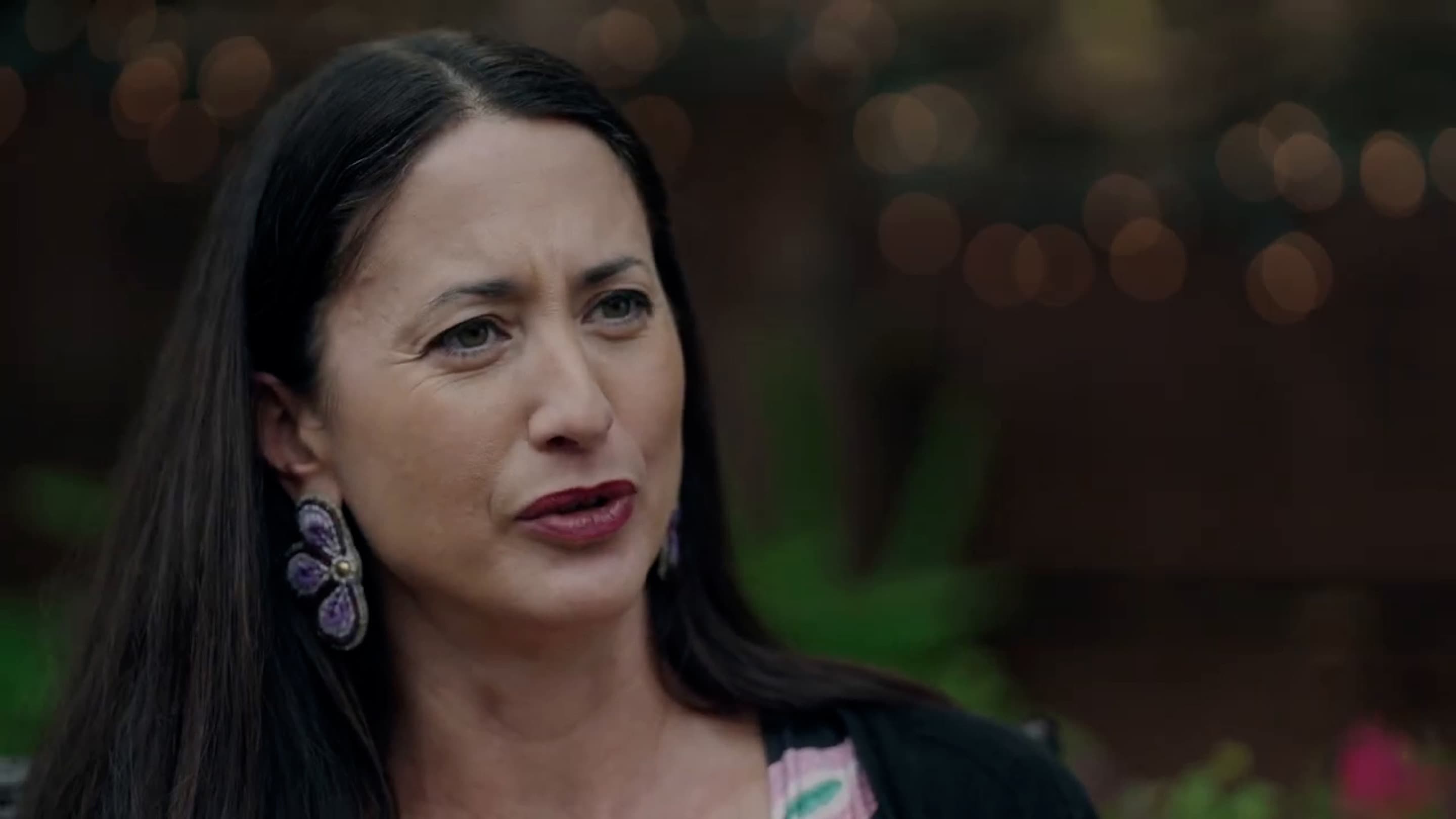 Elizabeth Hoover speaks to camera against a natural background in a still from the Indigenous Food Sovreignty video.