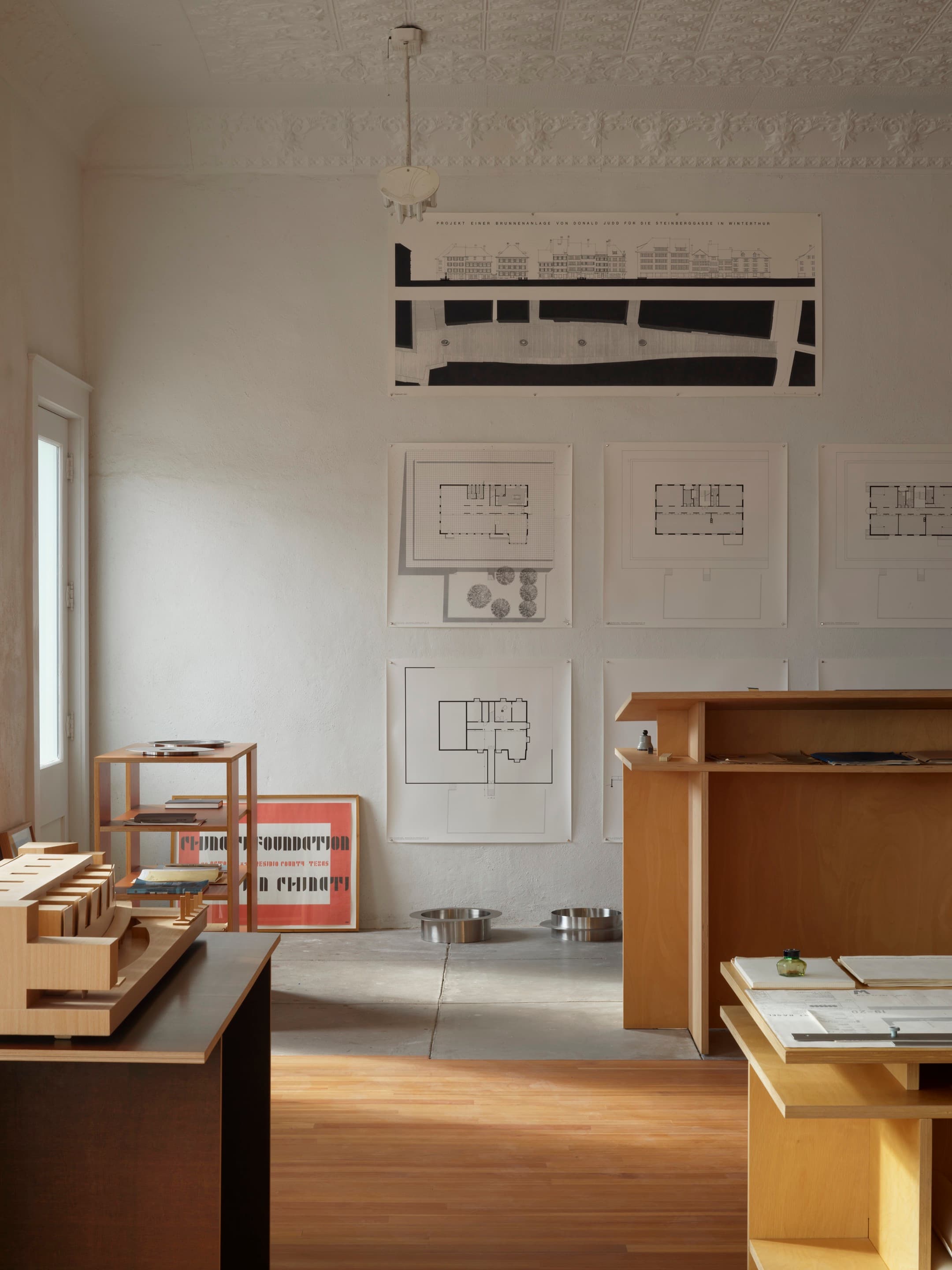 Technical architectural drawings by Donald Judd displayed on a wall in the Architecture Office, Marfa, Texas.