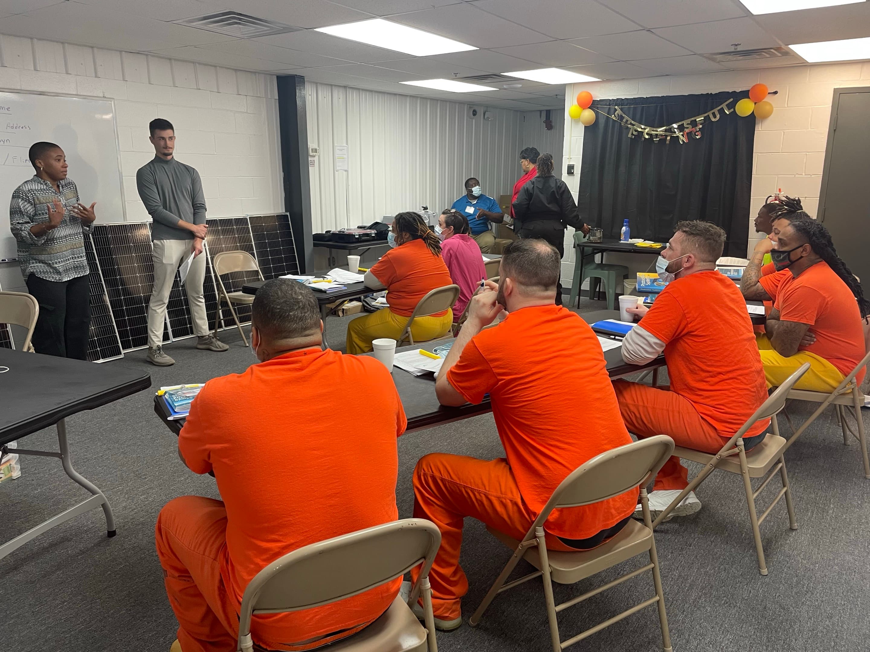 McKenna Dunbar leads a green skills training session in a Virginia prison classroom.