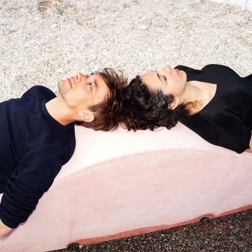 Giovanni Bellotti and Alessandra Covini of Studio Ossidiana lying head-to-head