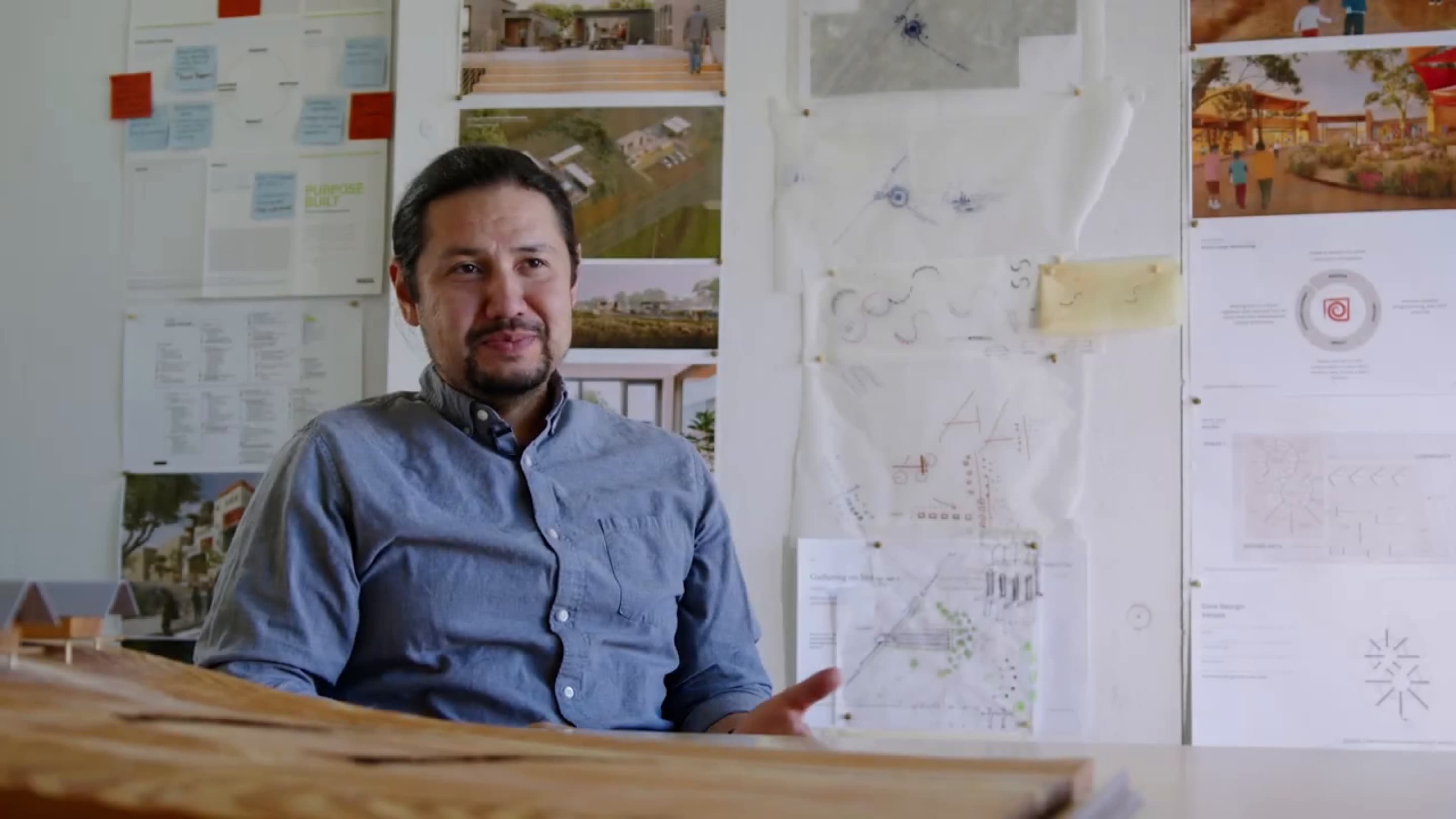 Joseph Kunkel speaks to camera from his studio in a still from the Sustainable Native Communities video.